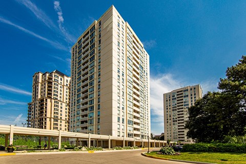 a group of tall buildings with a blue sky in the background